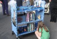 A young attendee inspects reading options offered by the Fumo Family Branch's ocean-blinged booktruck.